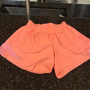 Women’s Lululemon shorts.  Size 2 Tall.  Color salmon/coral.  Great condition.